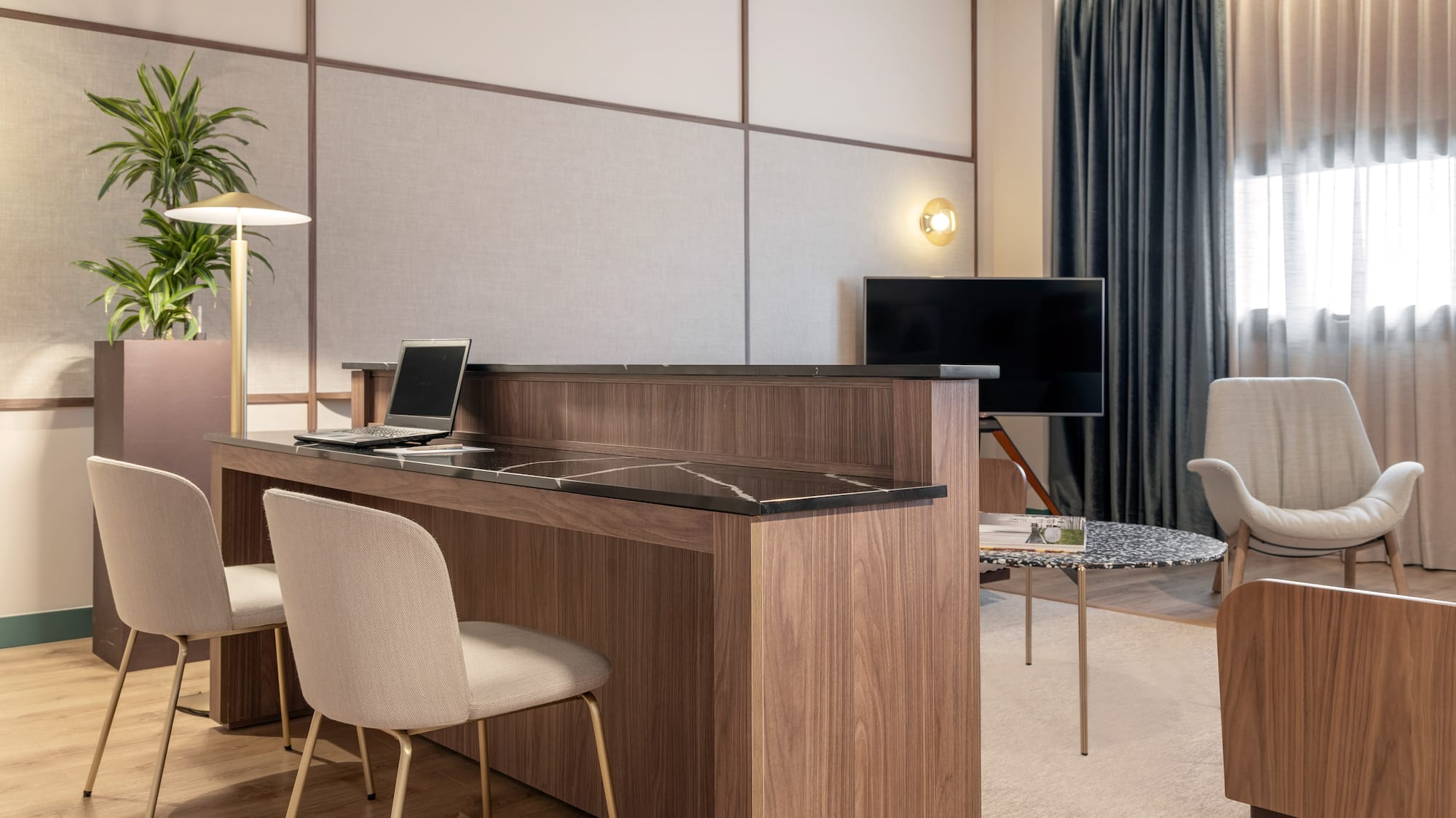 a room with a desk and chairs