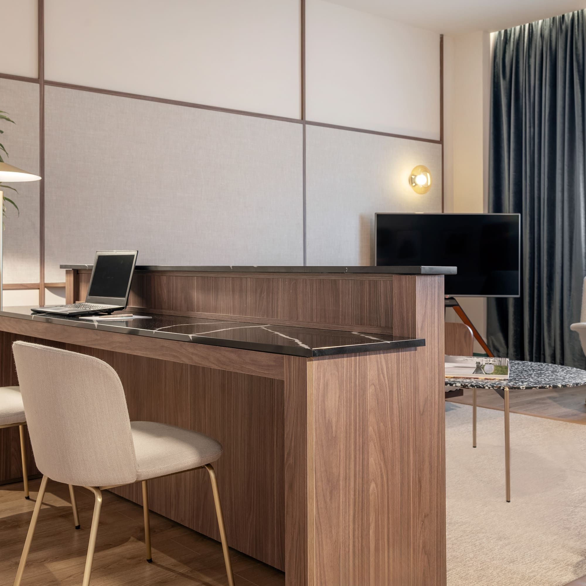 a room with a desk and chairs