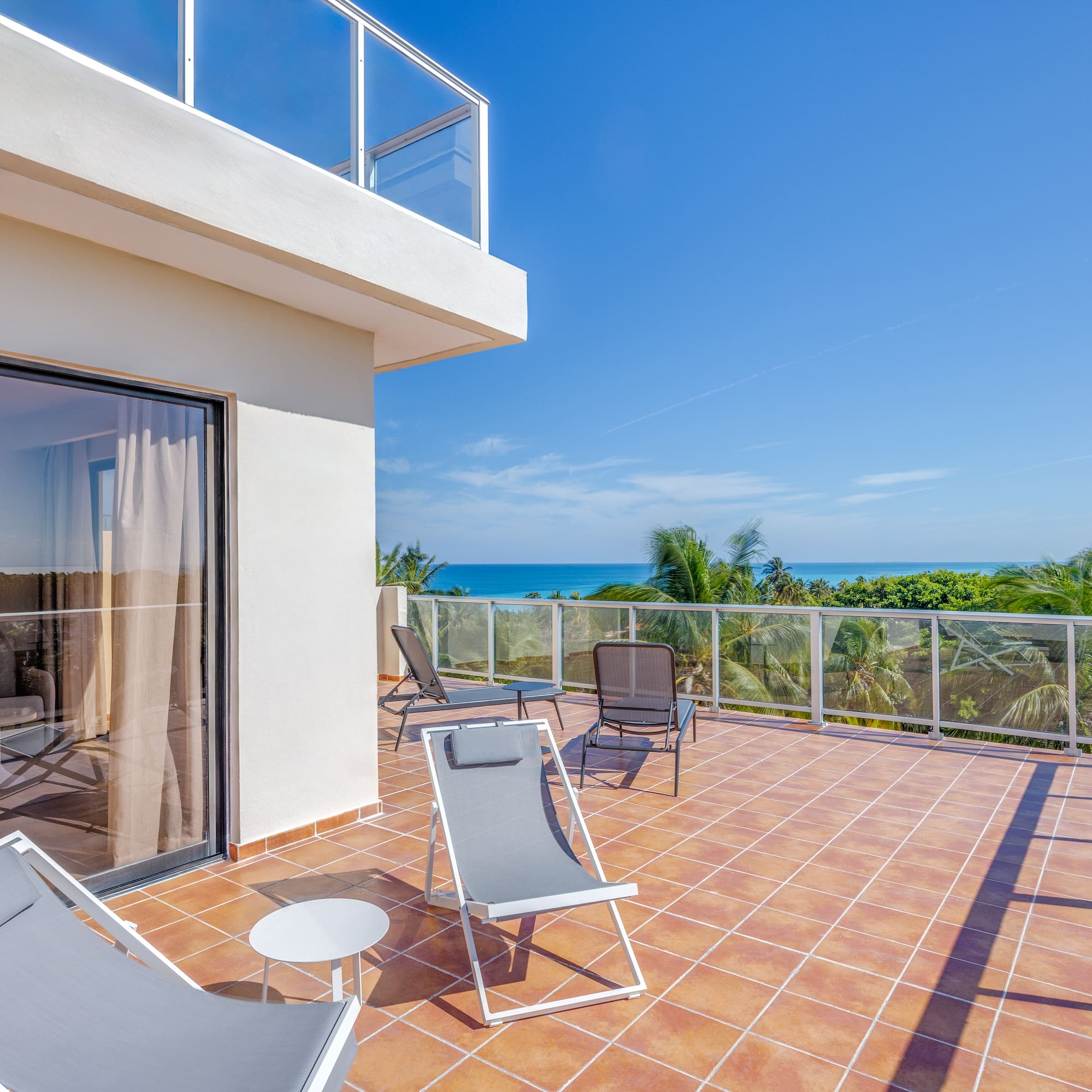 a deck with chairs and a glass door