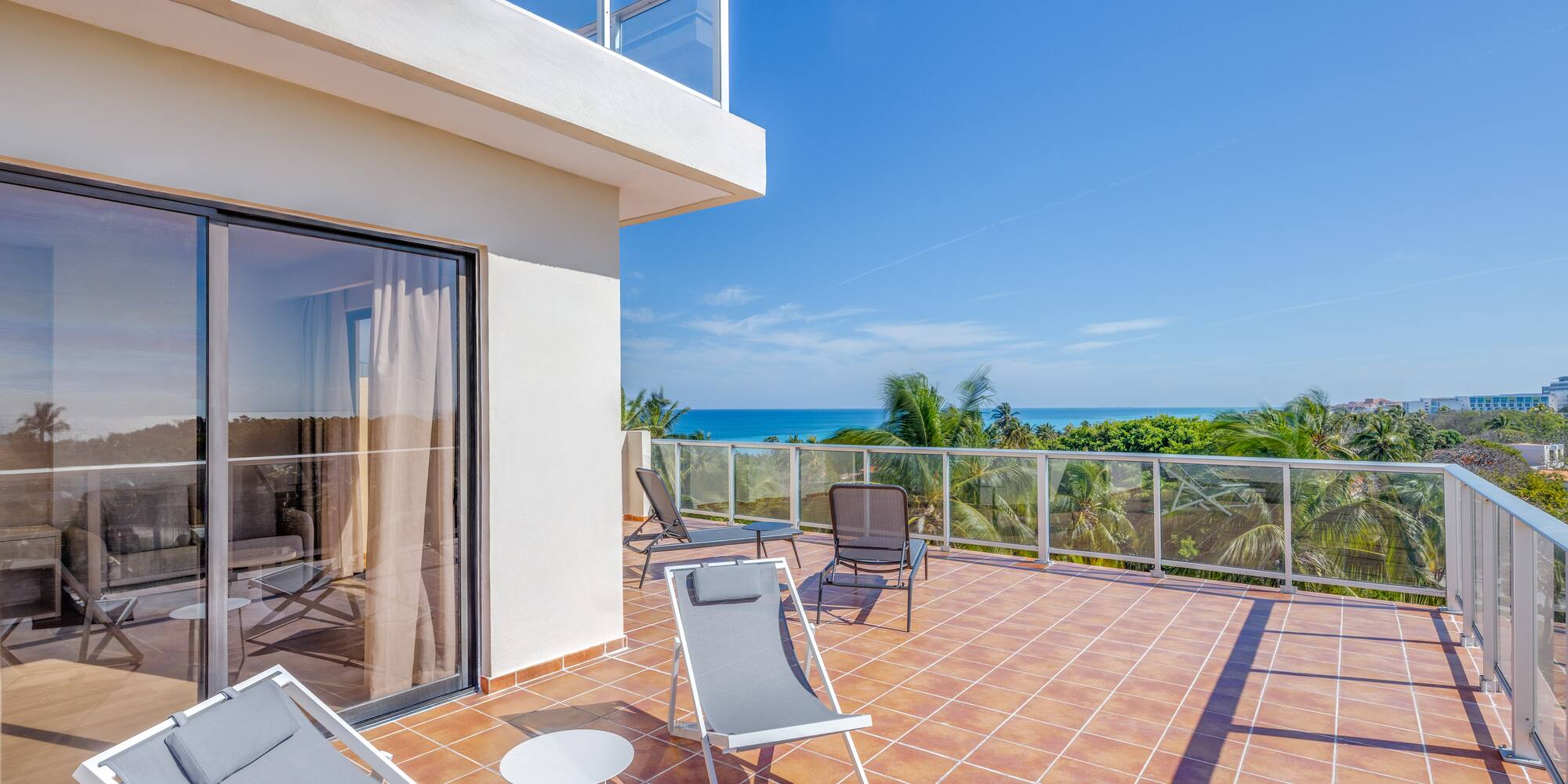 a deck with chairs and a glass door