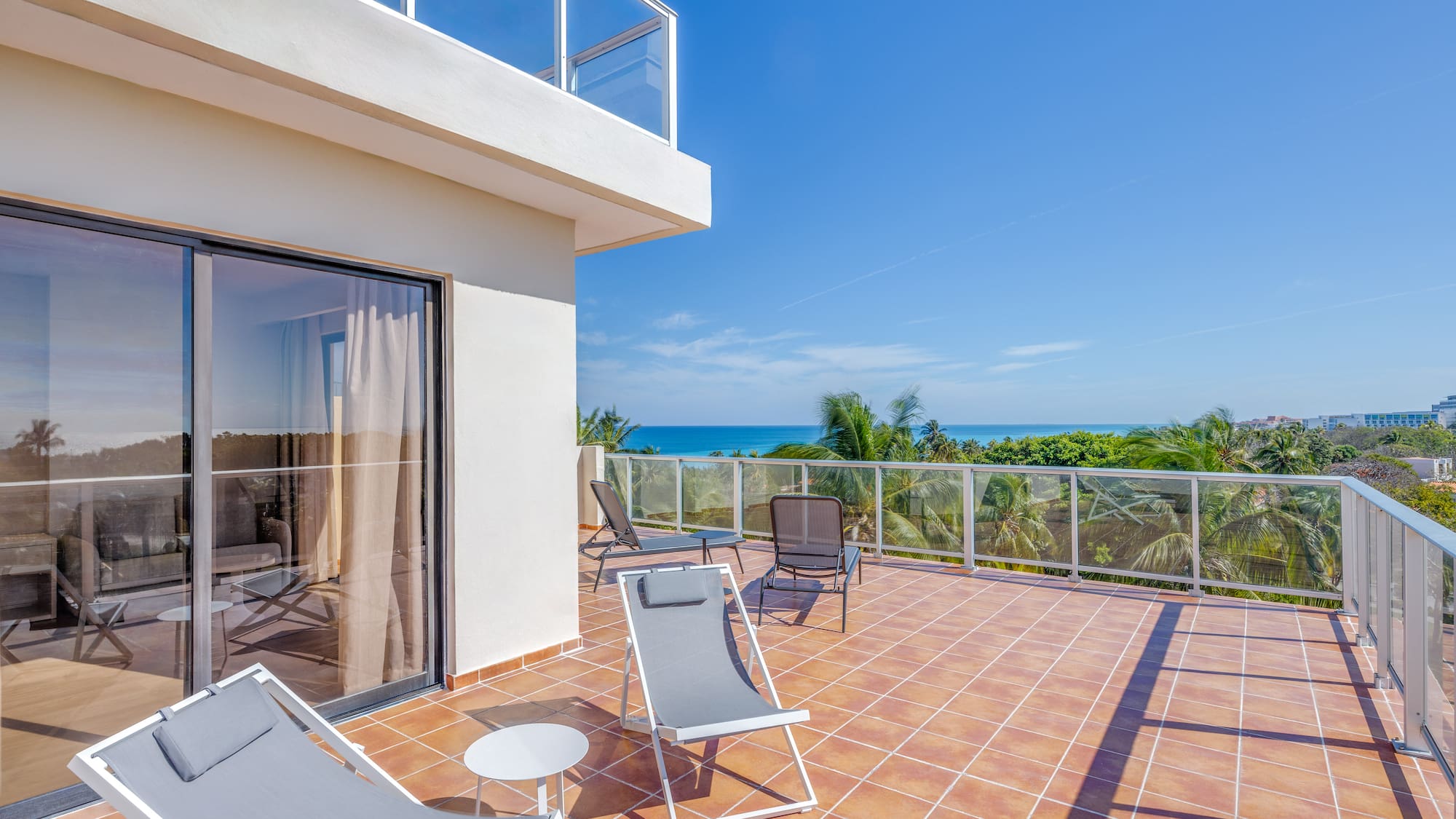 a deck with chairs and a glass door