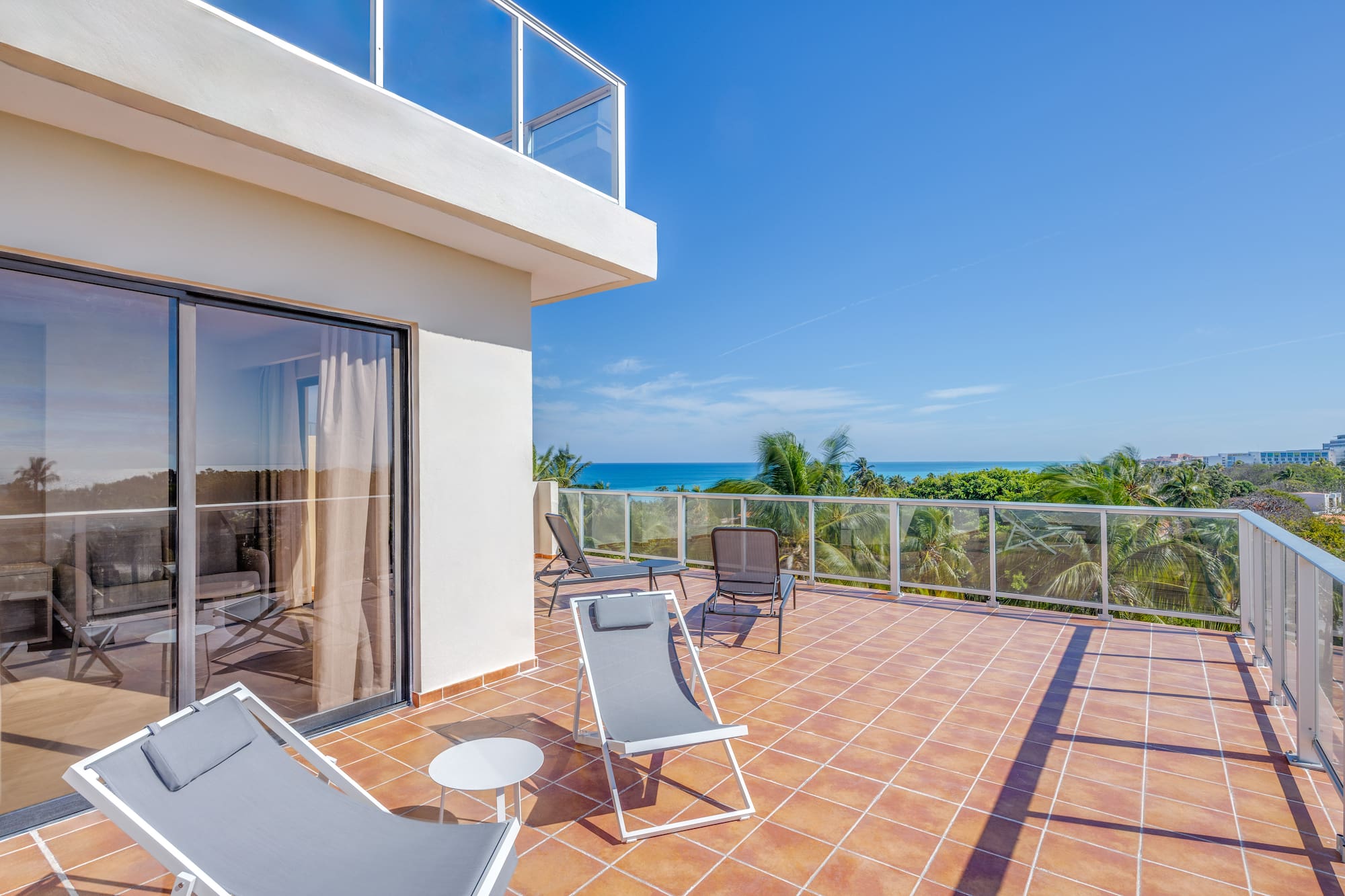 a deck with chairs and a glass door