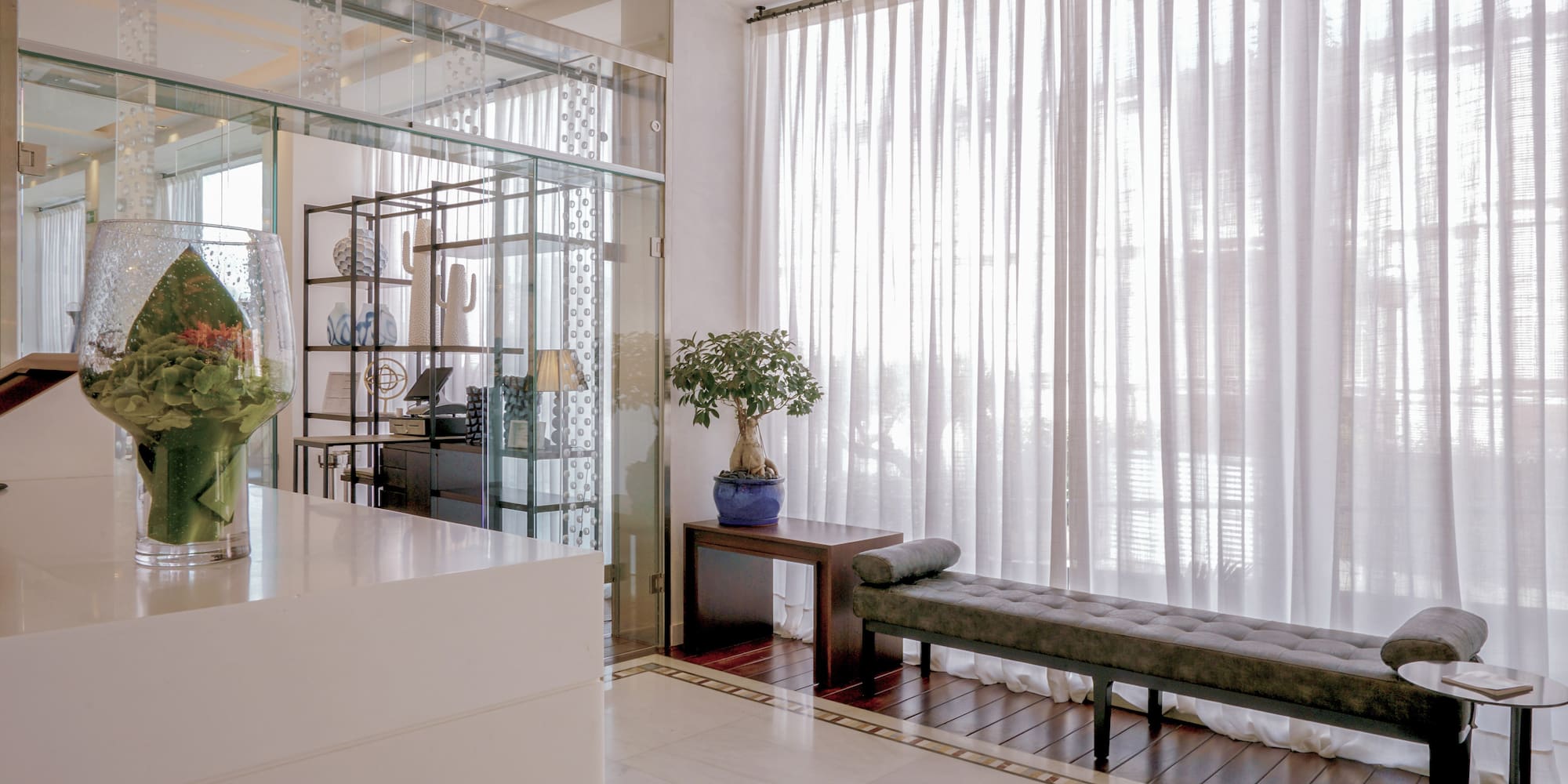 a room with a bench and a glass wall