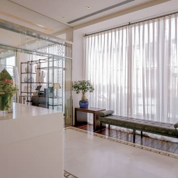 a room with a bench and a glass wall