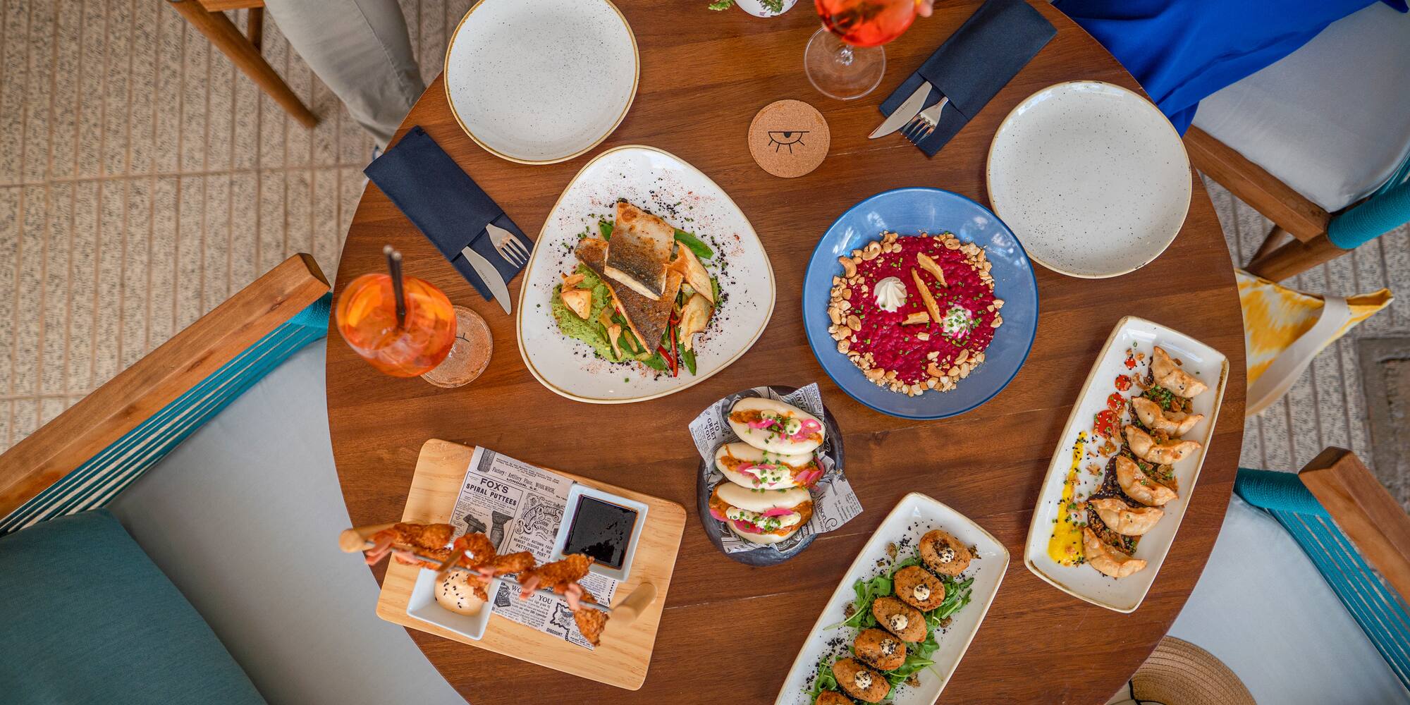 a table with plates of food and drinks