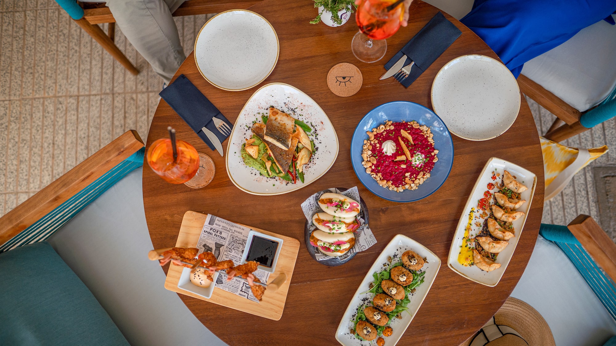 a table with plates of food and drinks