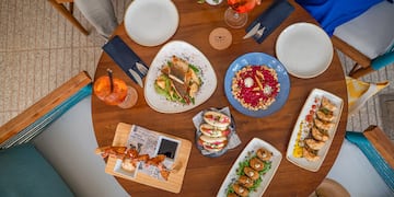 a table with plates of food and drinks
