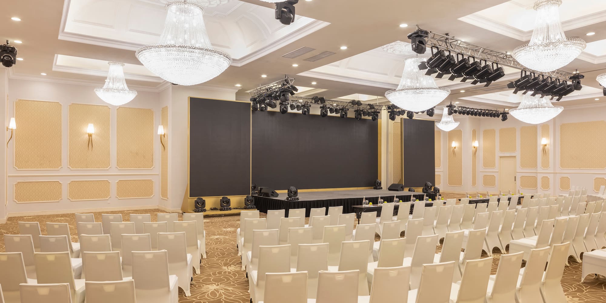 a room with white chairs and lights