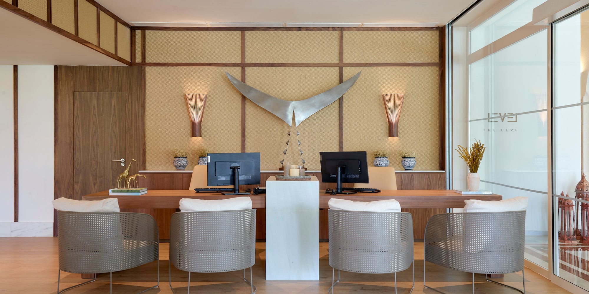 a room with a desk and chairs