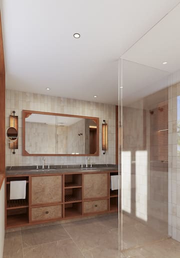 a bathroom with a glass shower and a large mirror