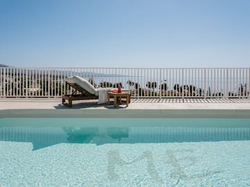 a pool with a chair and a table