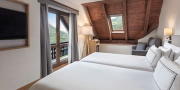 a bedroom with a wooden ceiling and a window