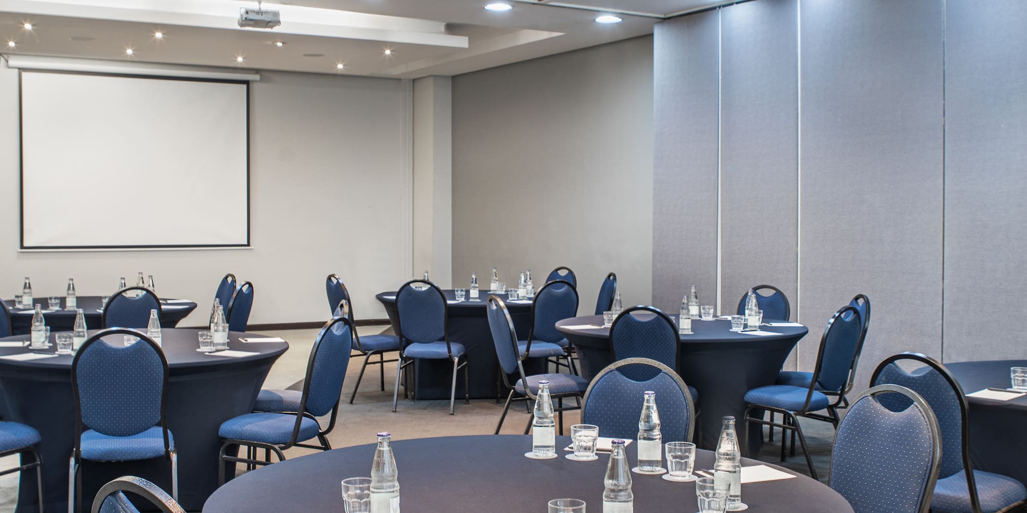 a room with round tables and chairs