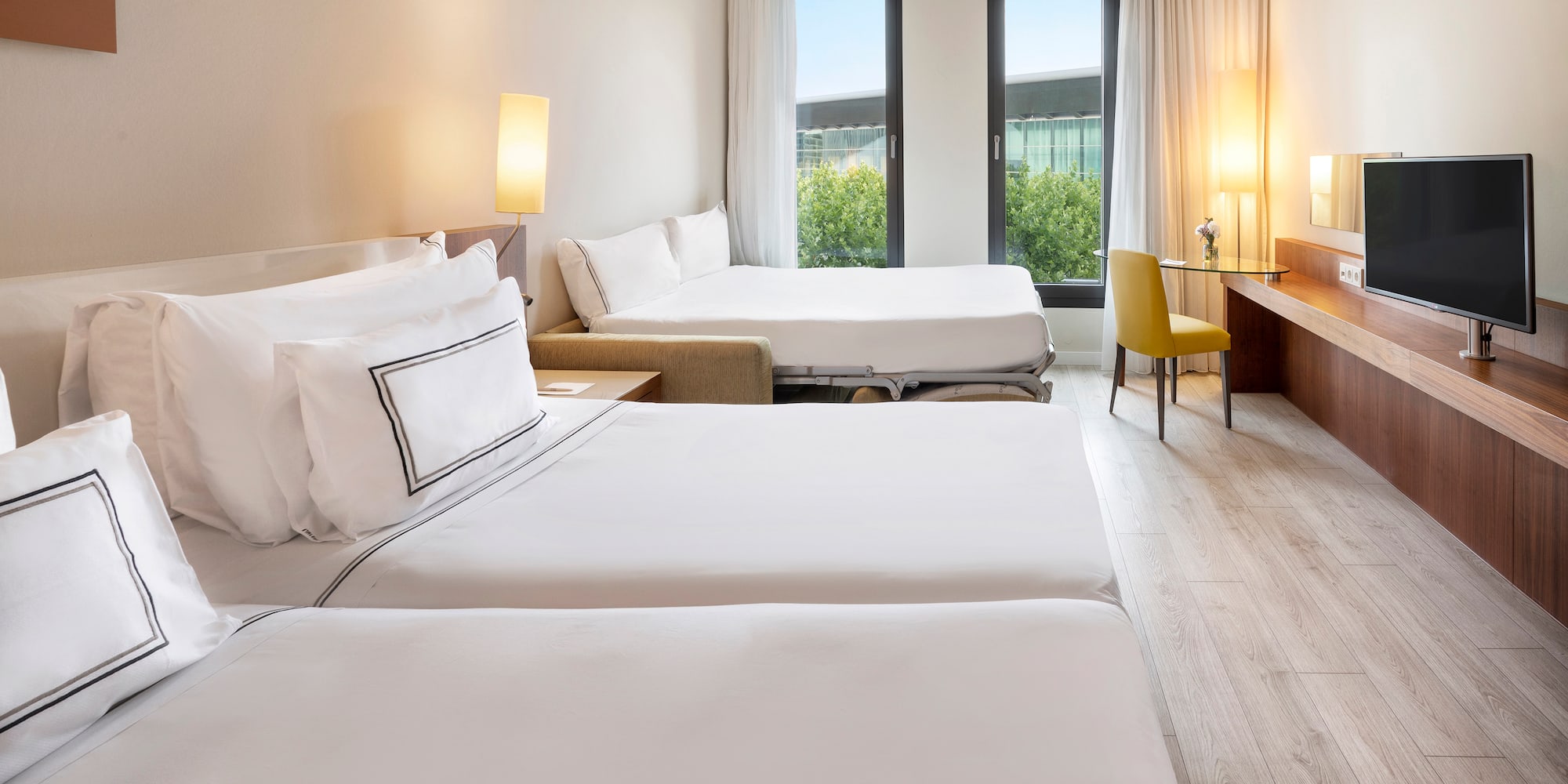 a room with two beds and a desk