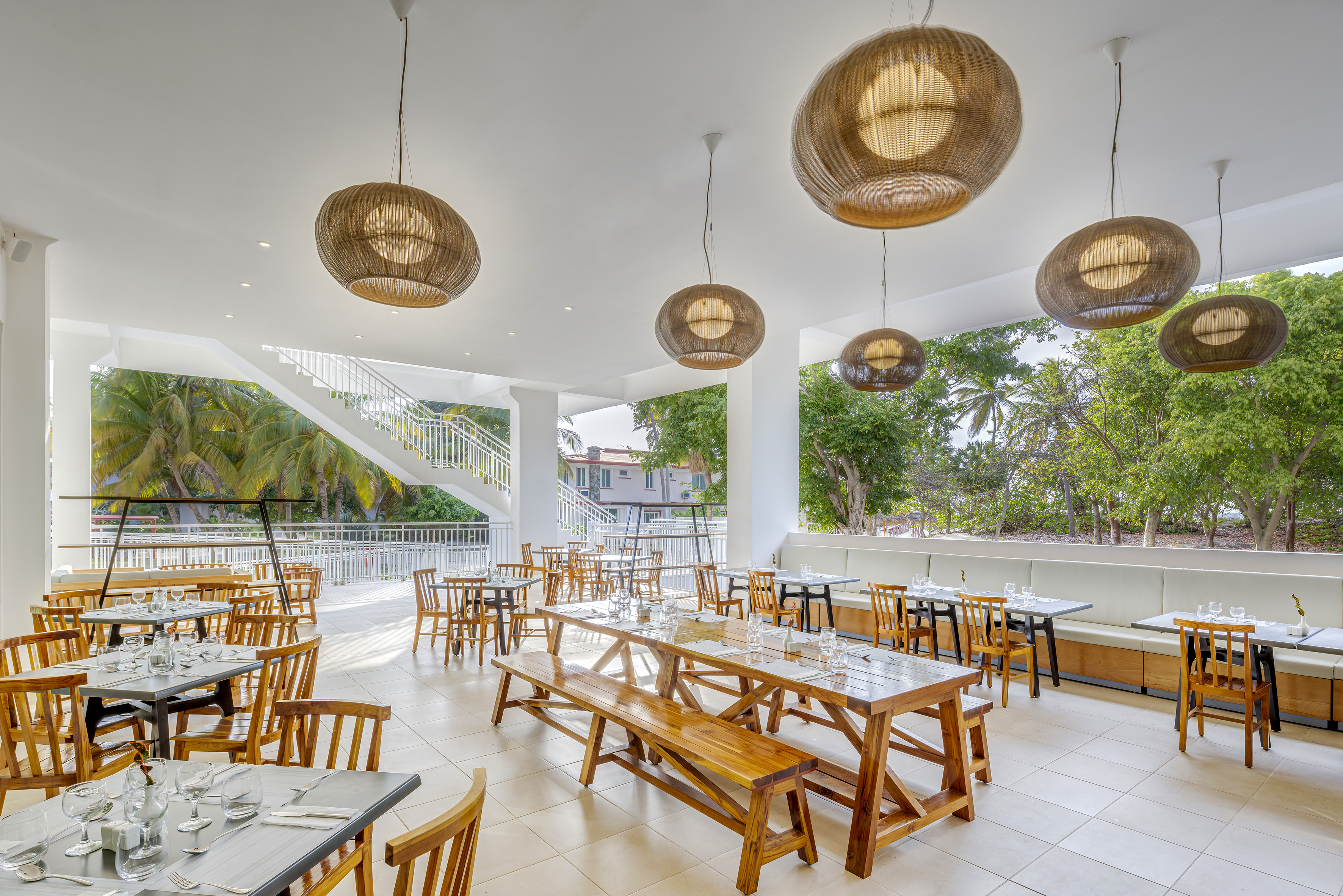 a room with tables and chairs and a staircase