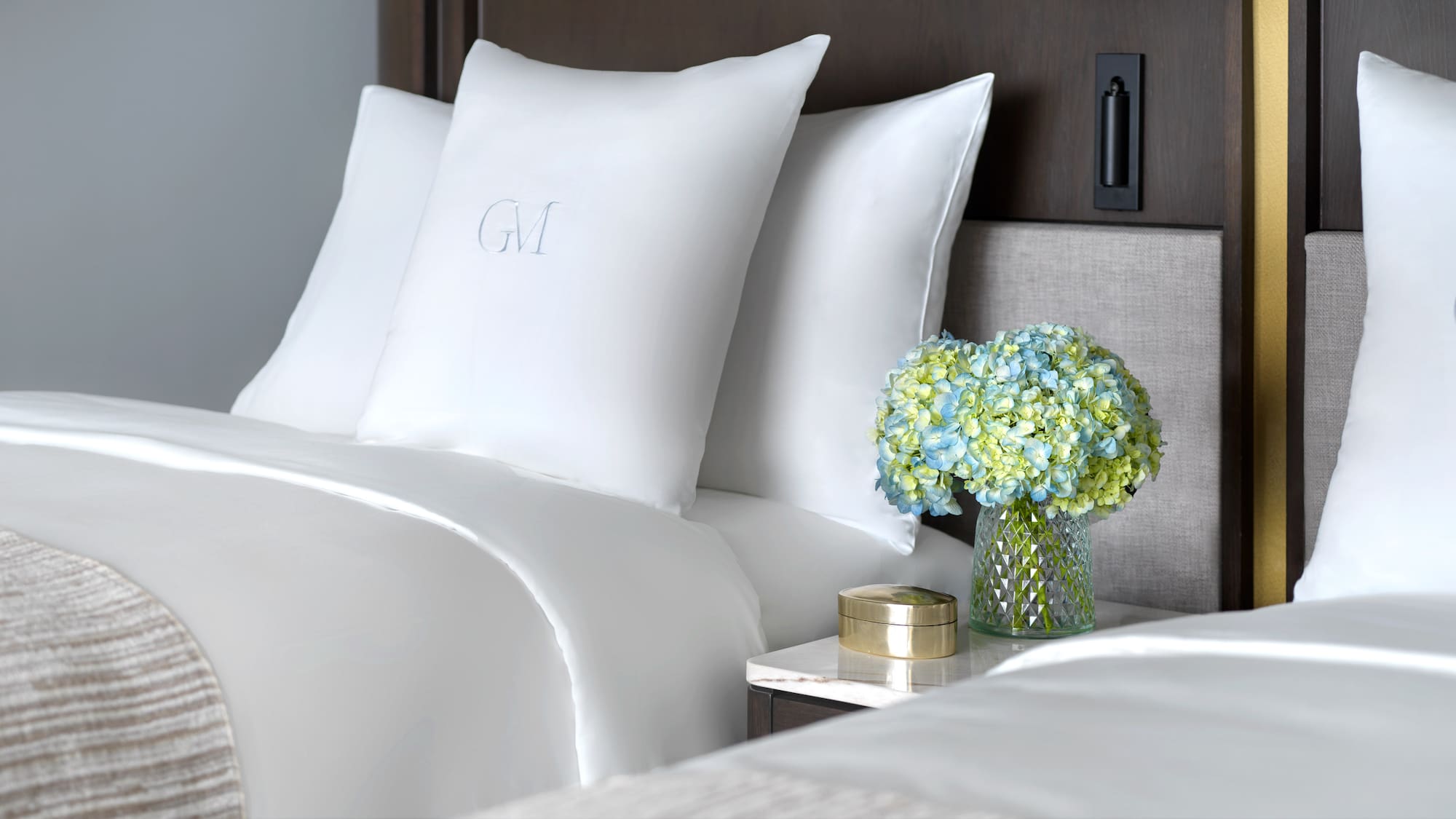 a vase of flowers and pillows on a table