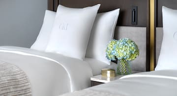 a vase of flowers and pillows on a table