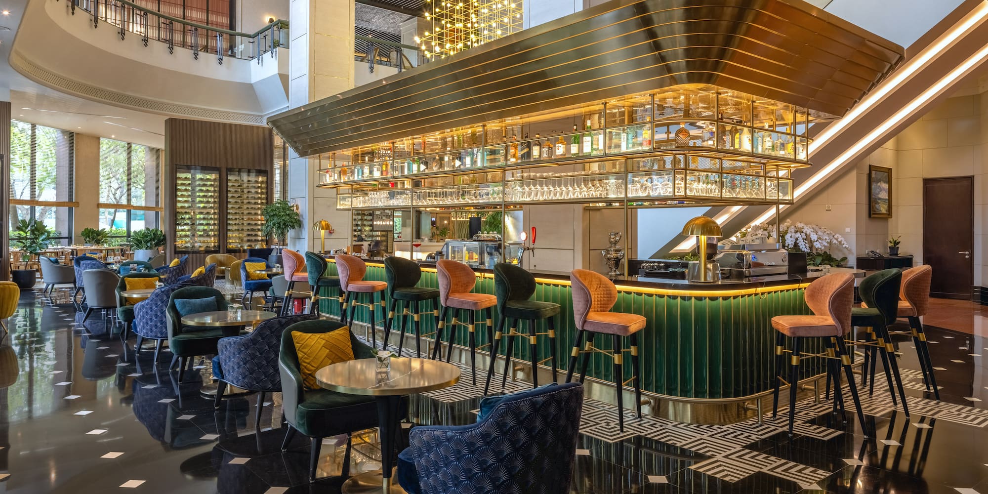 a bar with colorful chairs and a bar