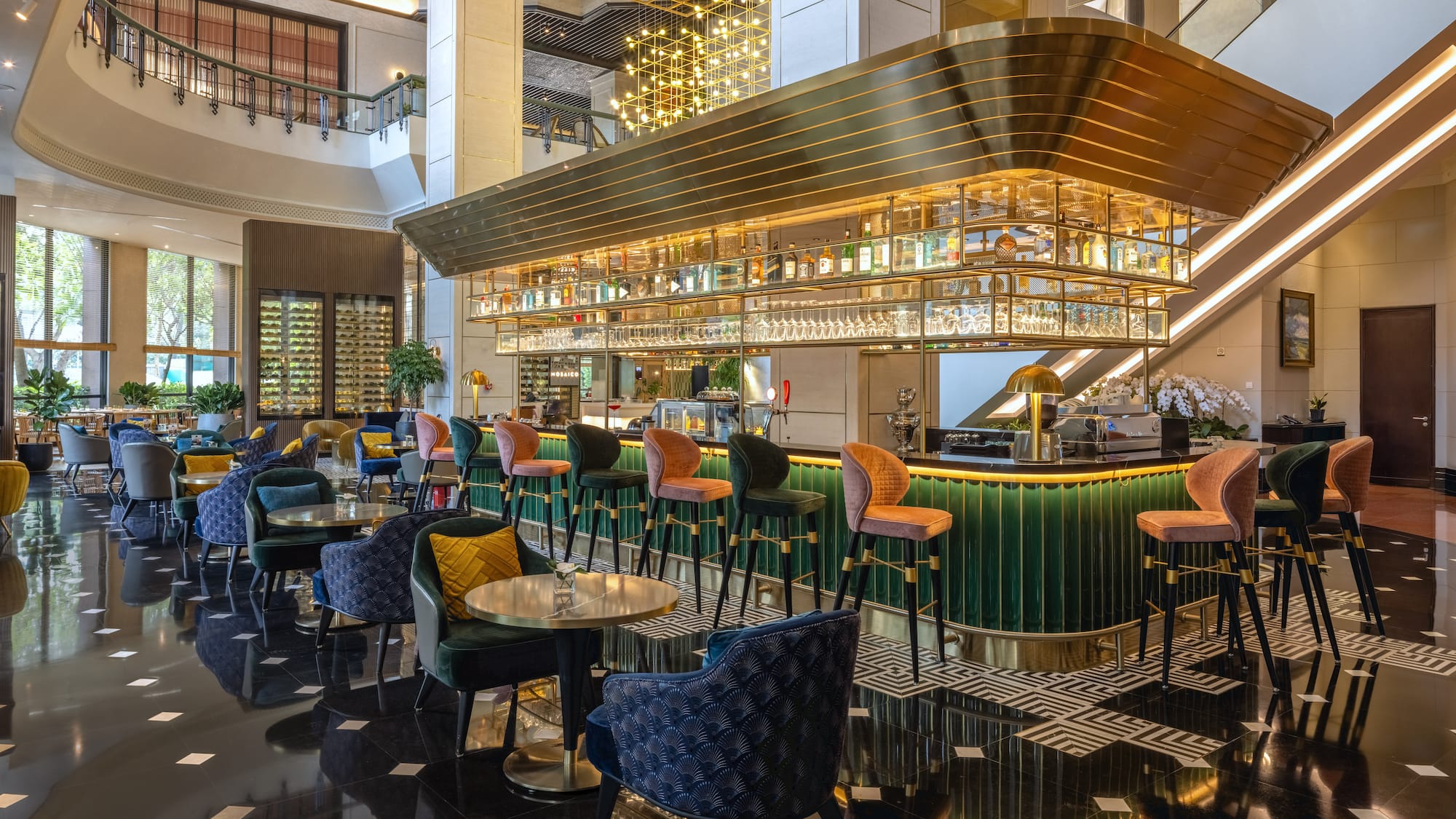 a bar with colorful chairs and a bar