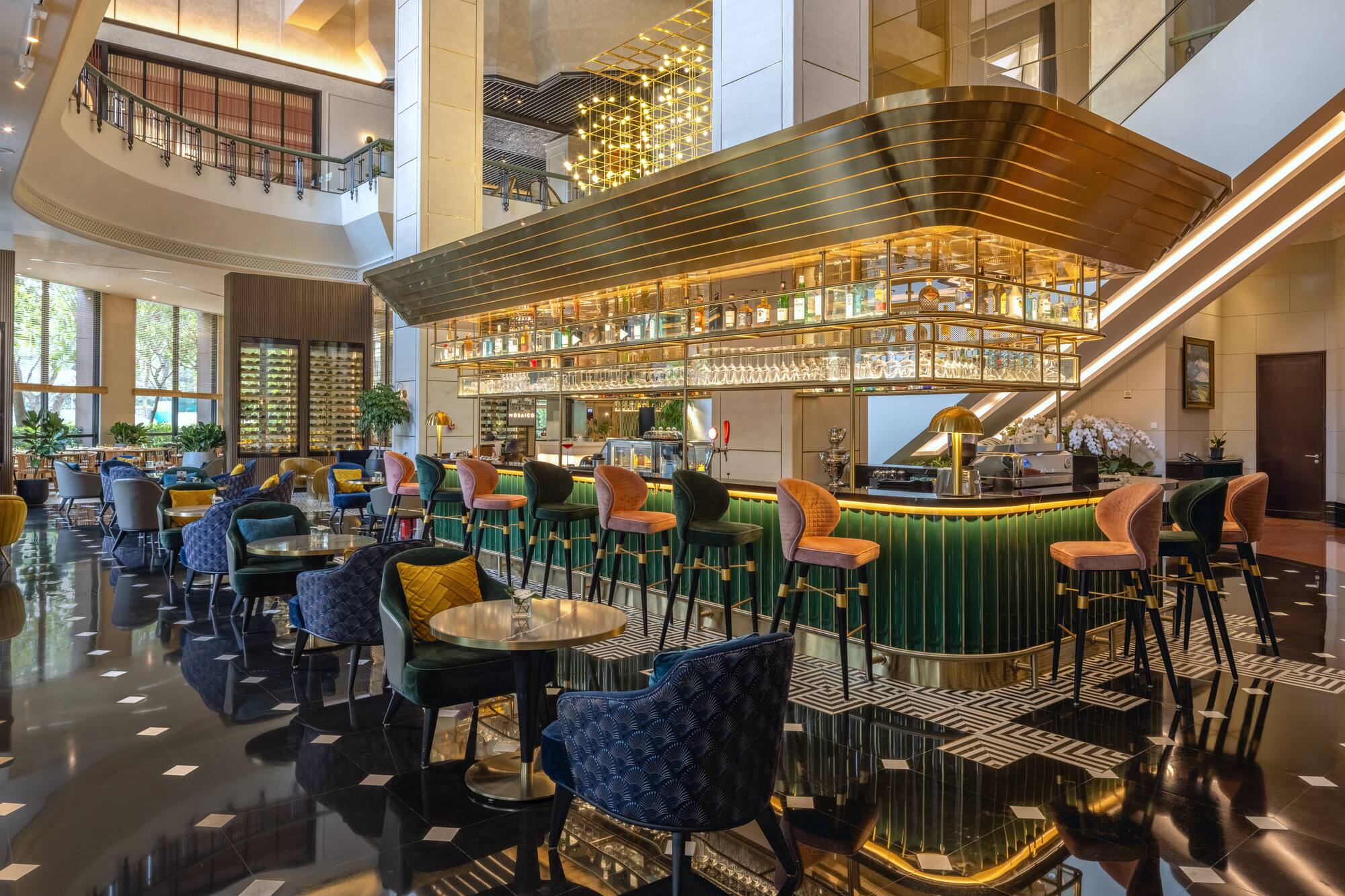 a bar with colorful chairs and a bar
