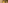 Ornate window, iron balcony on elegant building facade with green leaves.