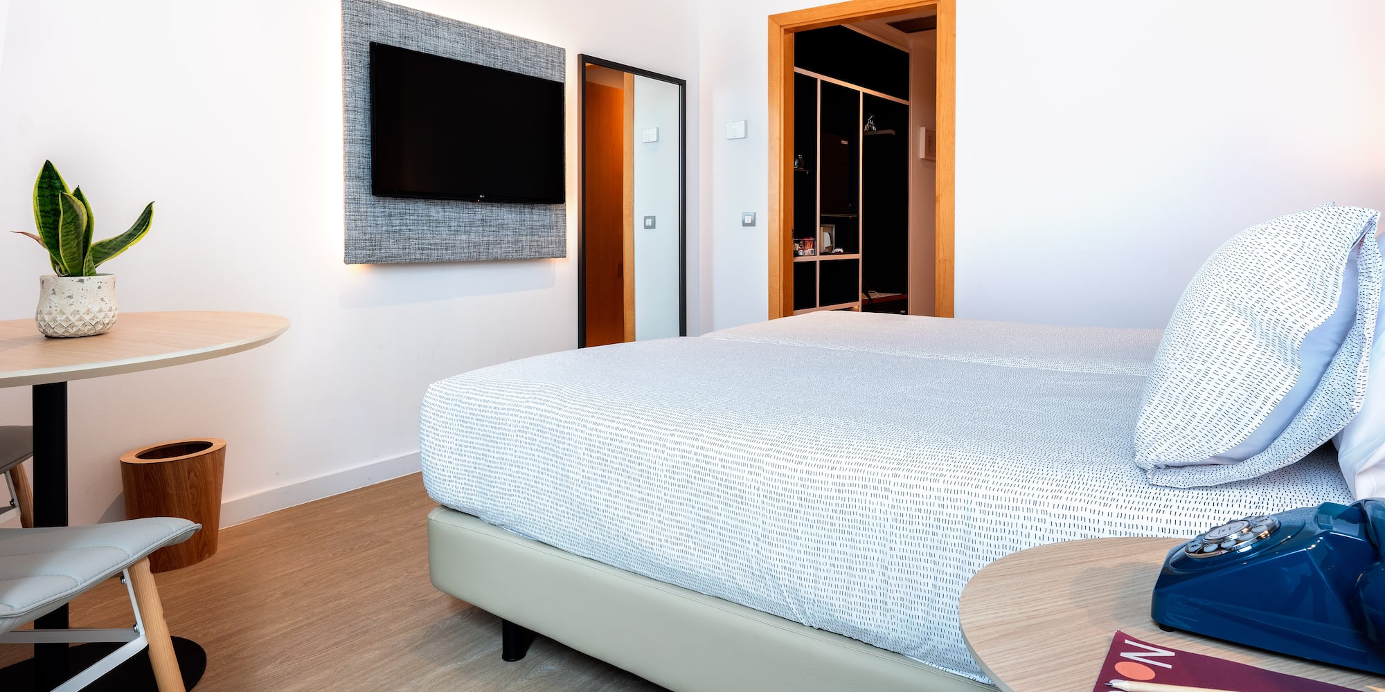 a room with a bed and a tv