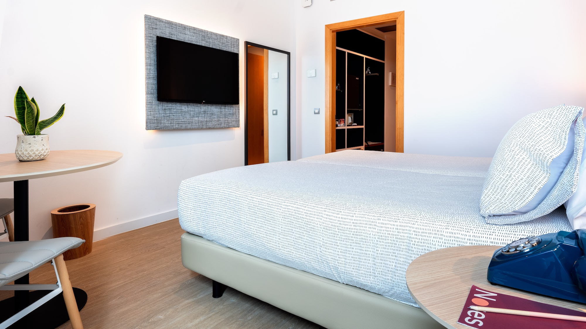 a room with a bed and a tv