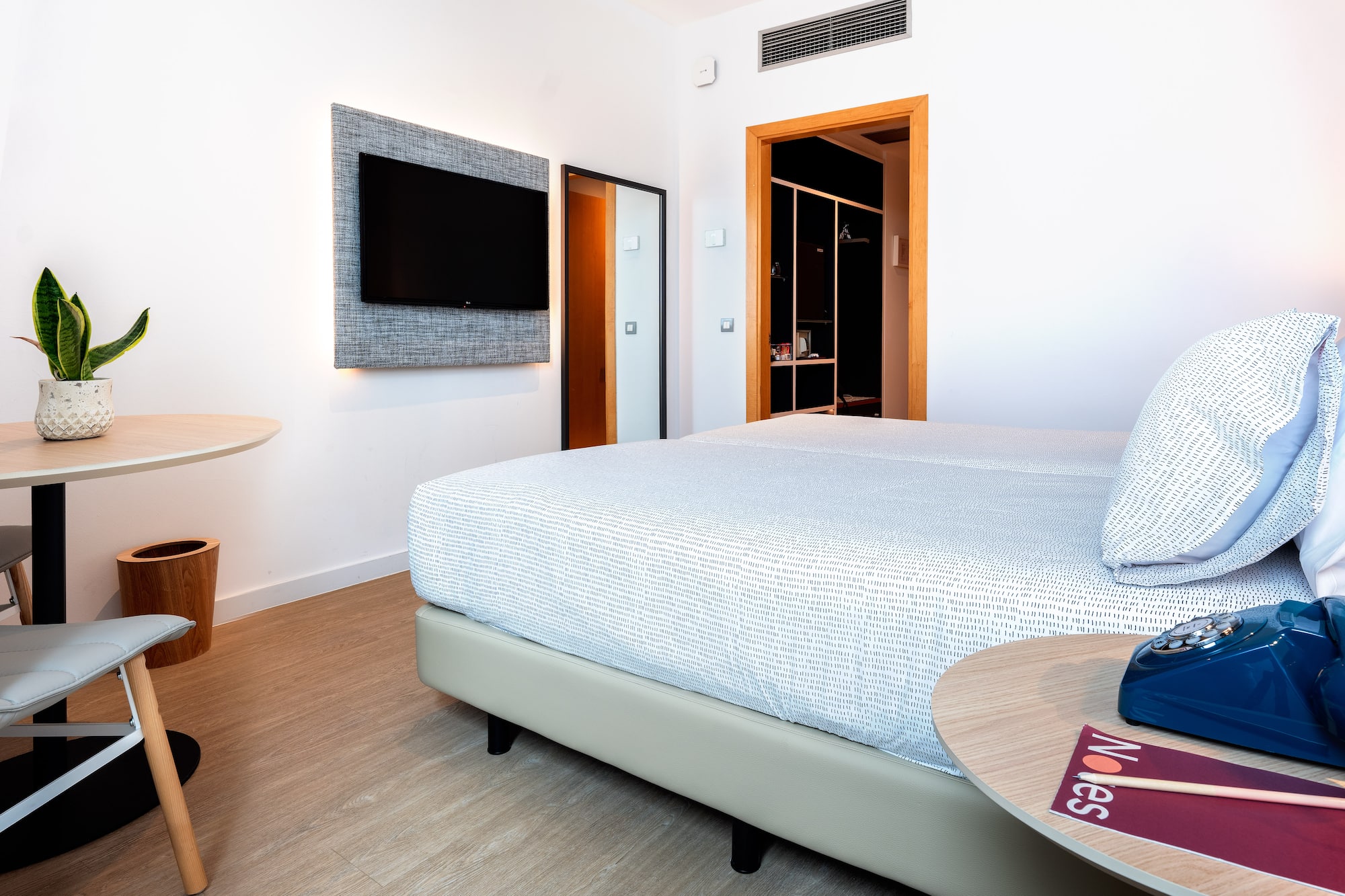 a room with a bed and a tv