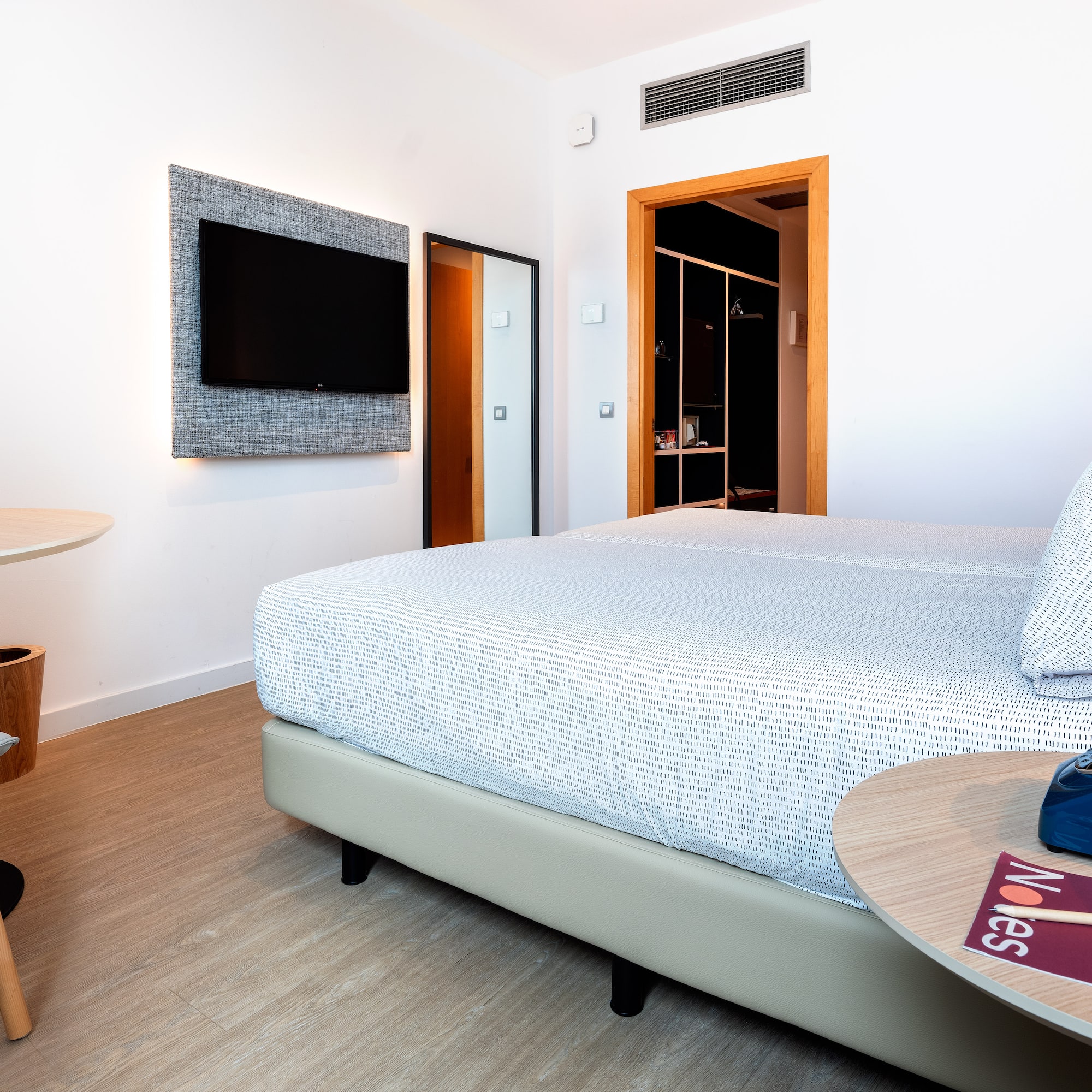 a room with a bed and a tv