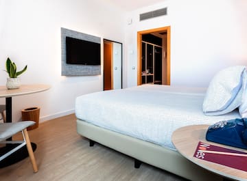 a room with a bed and a tv