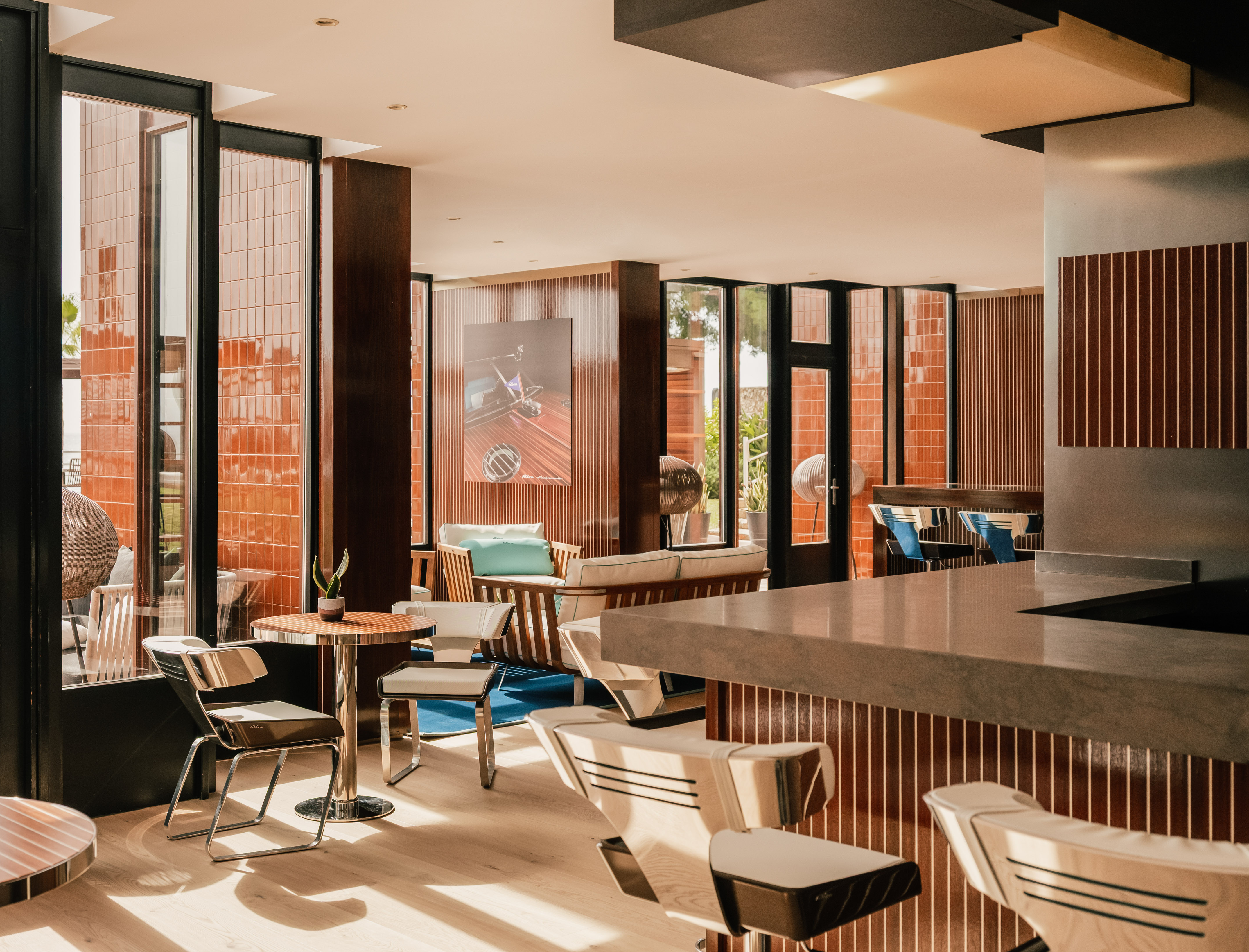 Stylish hotel lounge bar with wood, orange tiles, and modern seating.