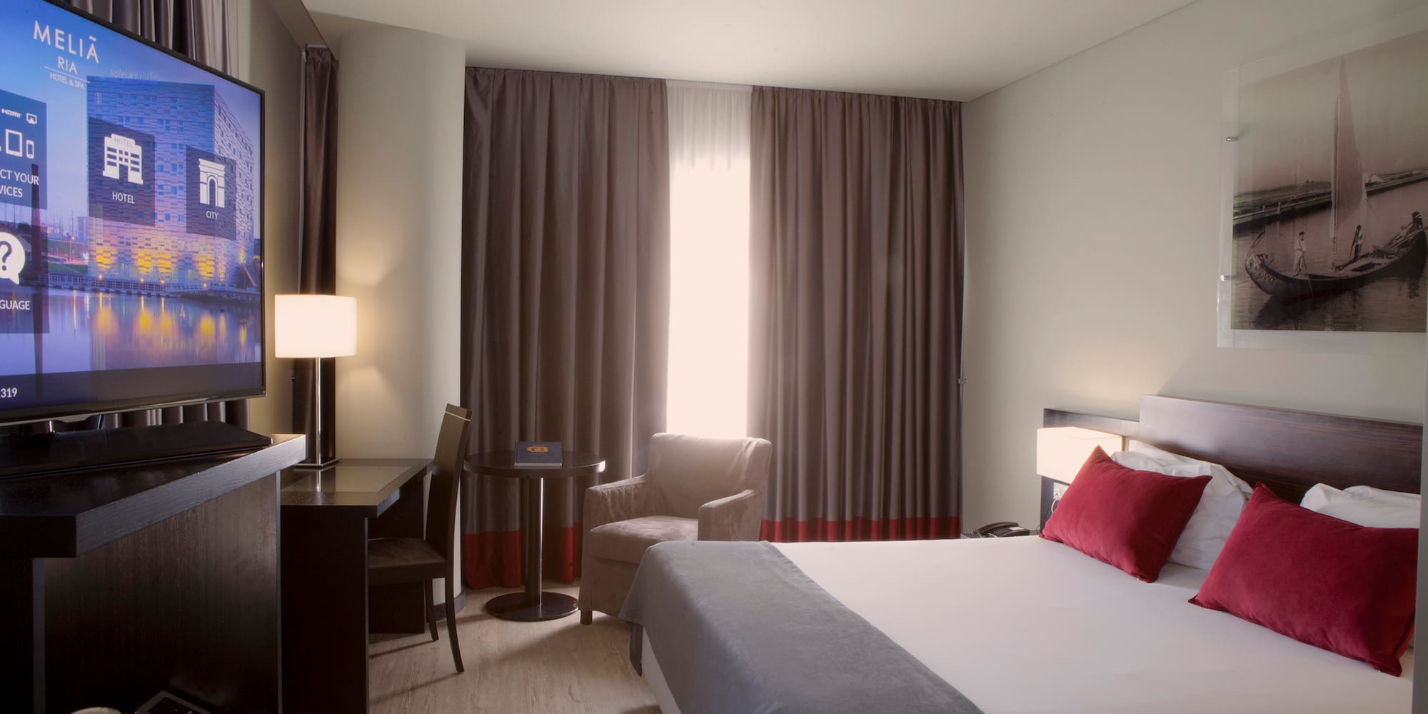 a room with a bed and a television