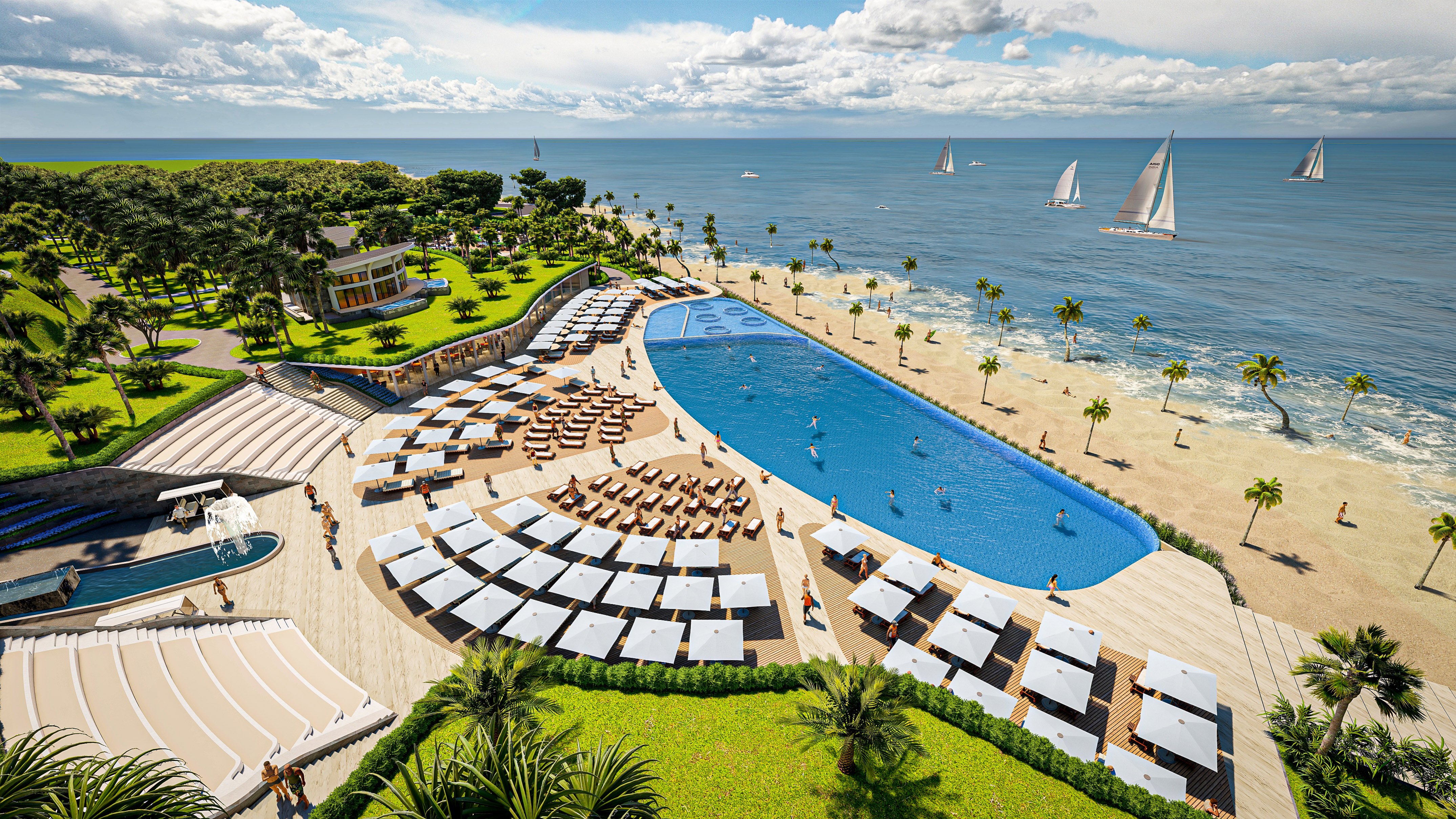 Aerial view: Luxury beachfront resort, large pool, sandy beach, ocean, sailboats.