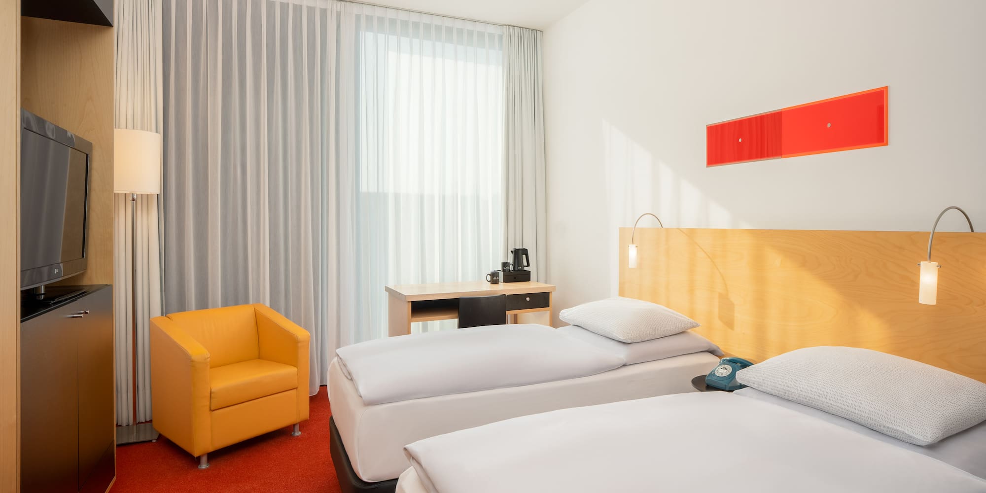 a room with two beds and a chair