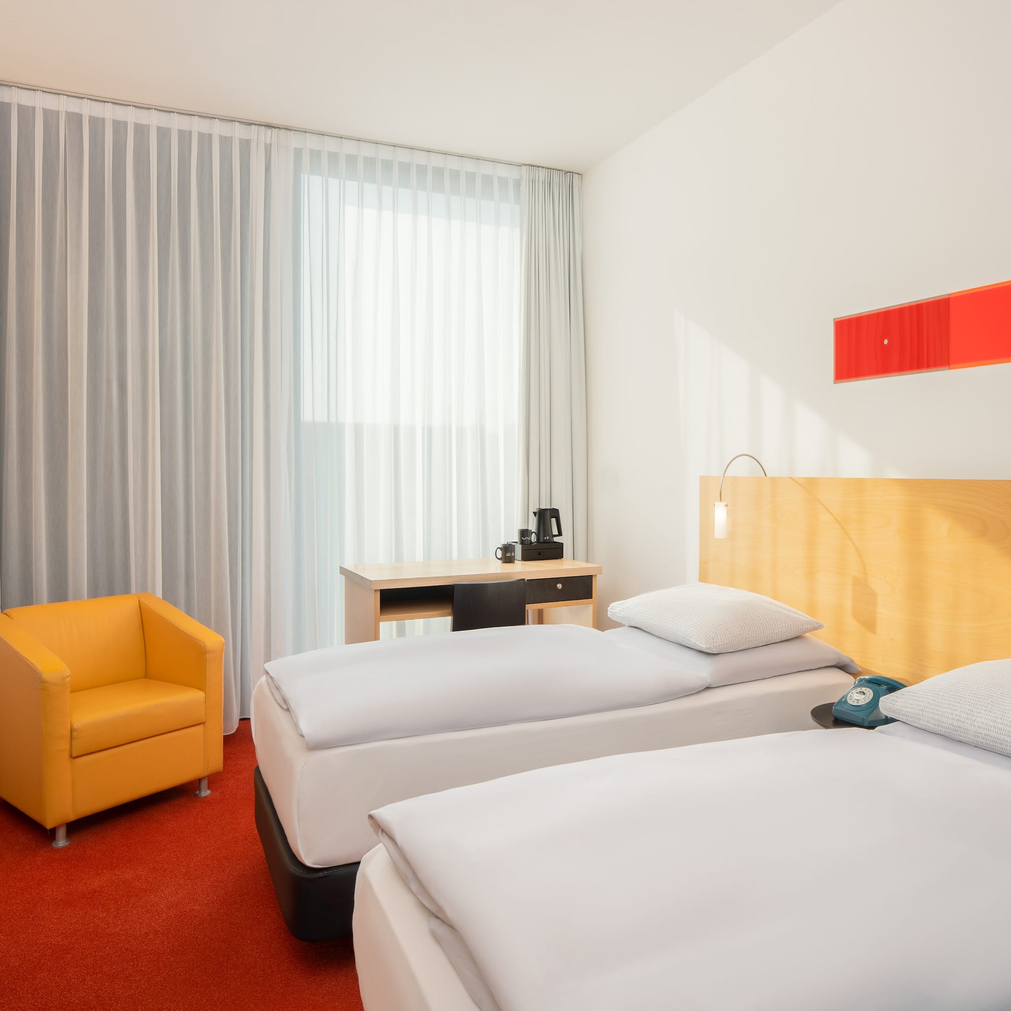 a room with two beds and a chair