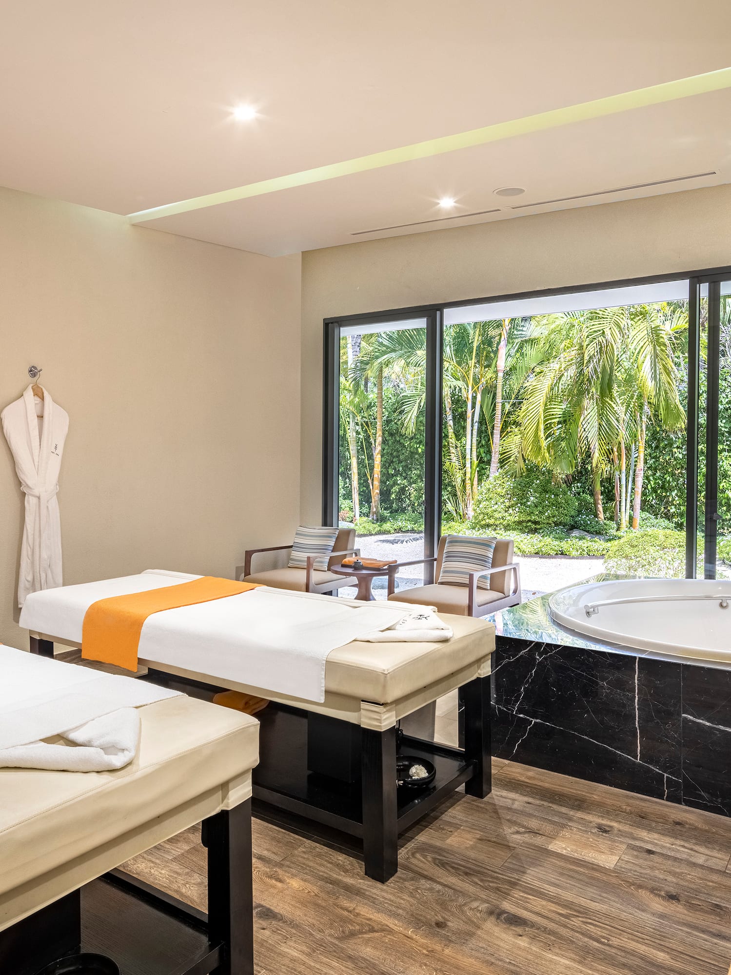 a room with beds and a hot tub