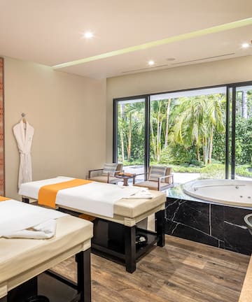 a room with beds and a hot tub