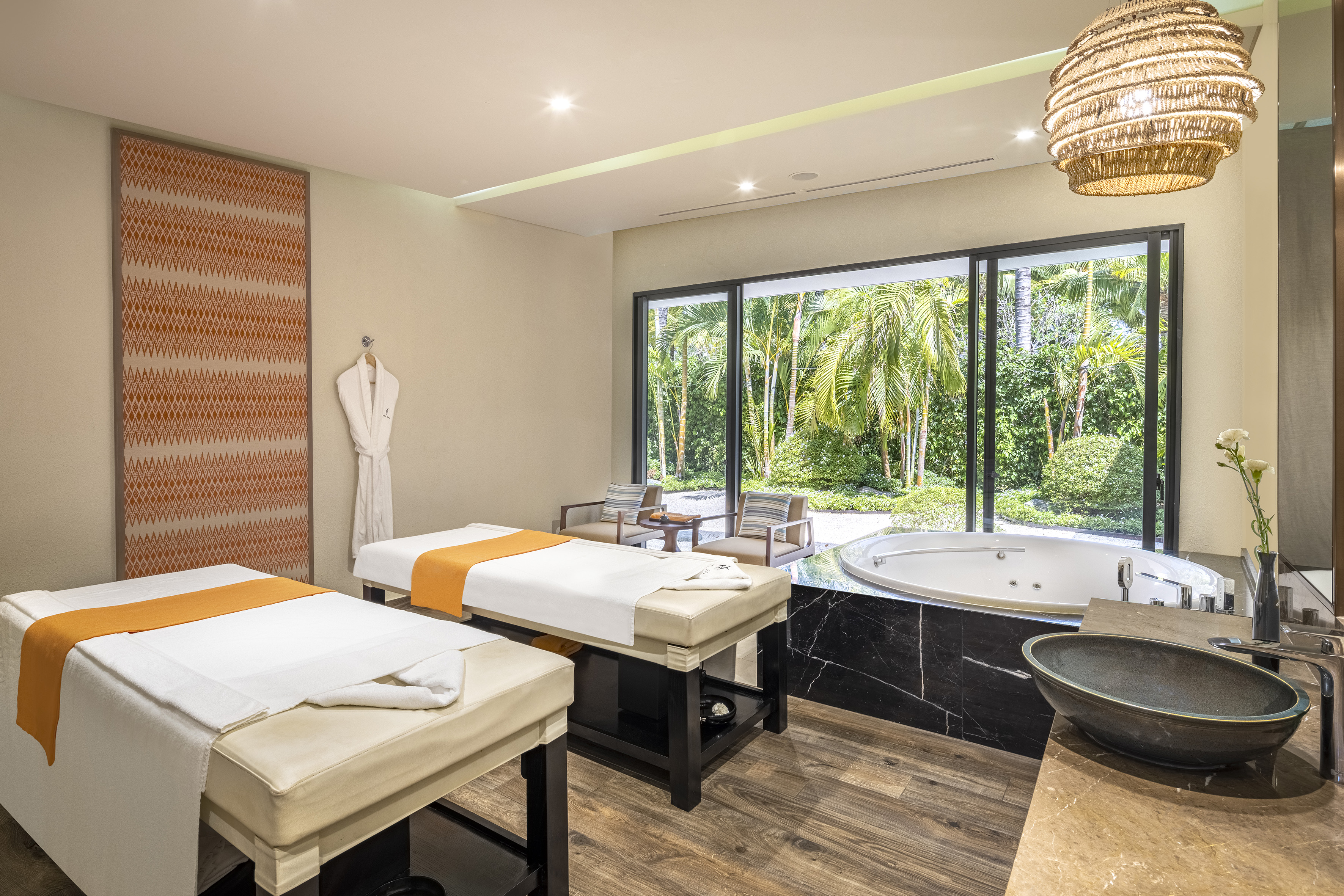 a room with beds and a hot tub