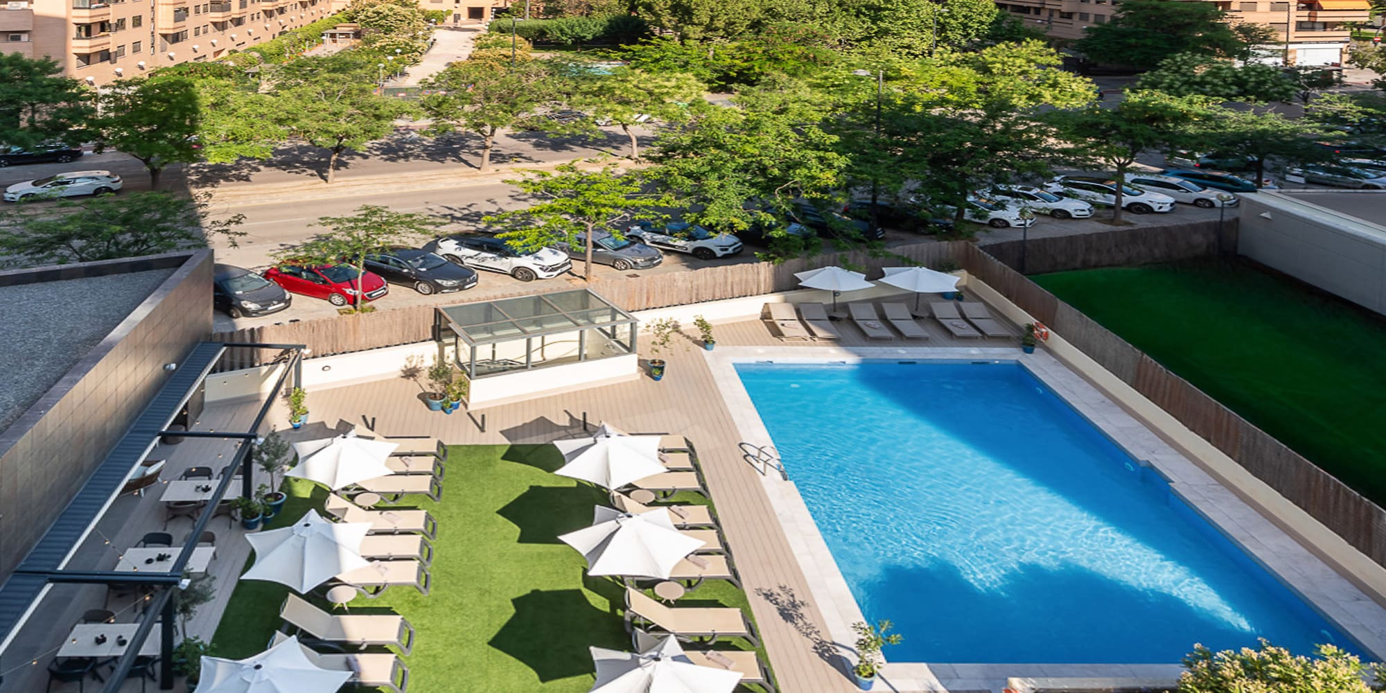 a pool and umbrellas in a parking lot