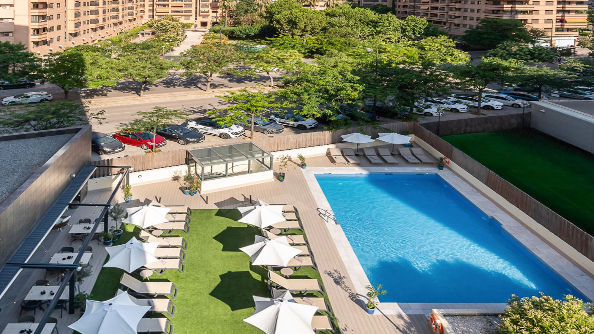 a pool and umbrellas in a parking lot