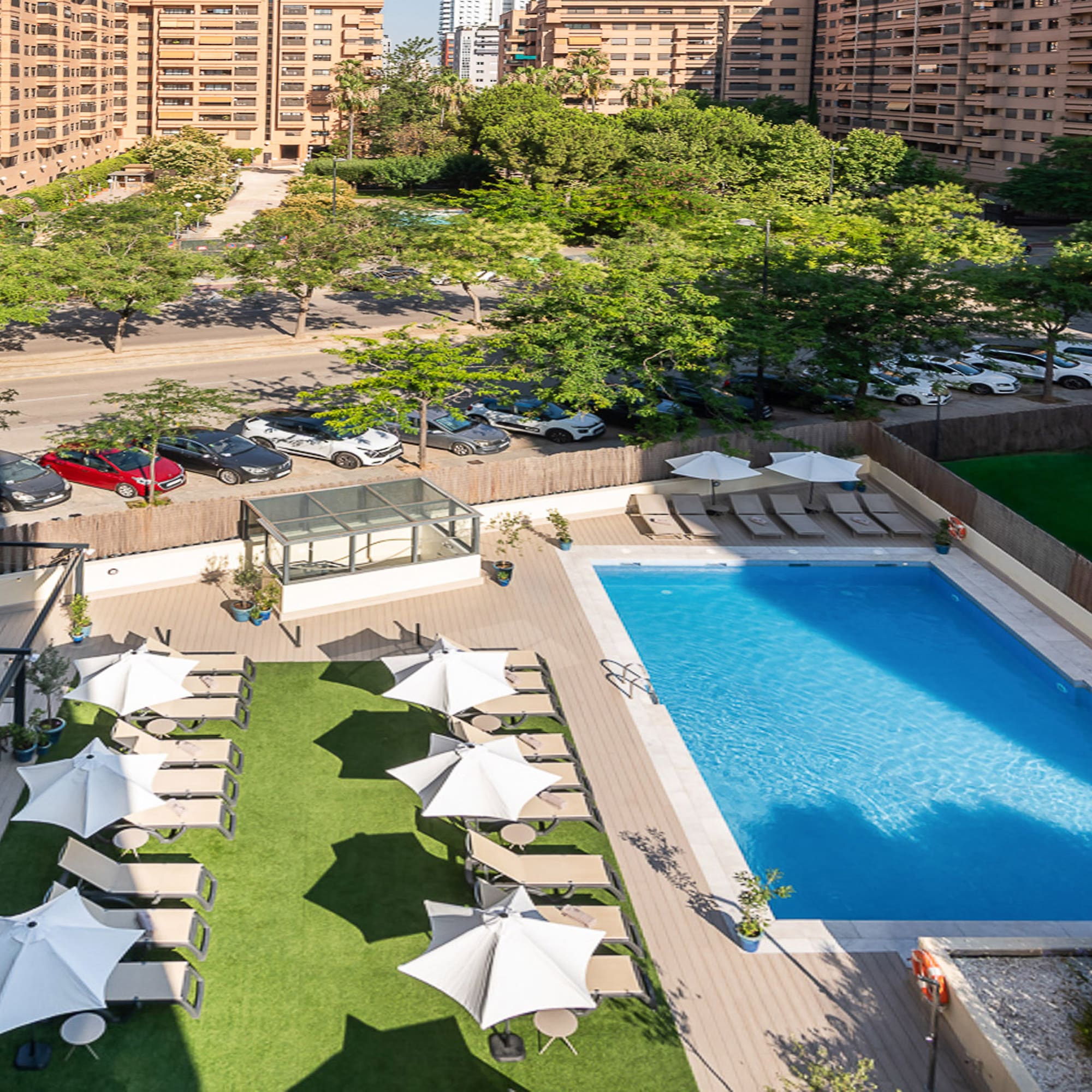 a pool and umbrellas in a parking lot