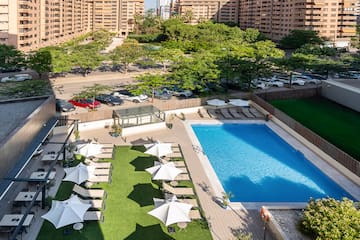 a pool and umbrellas in a parking lot
