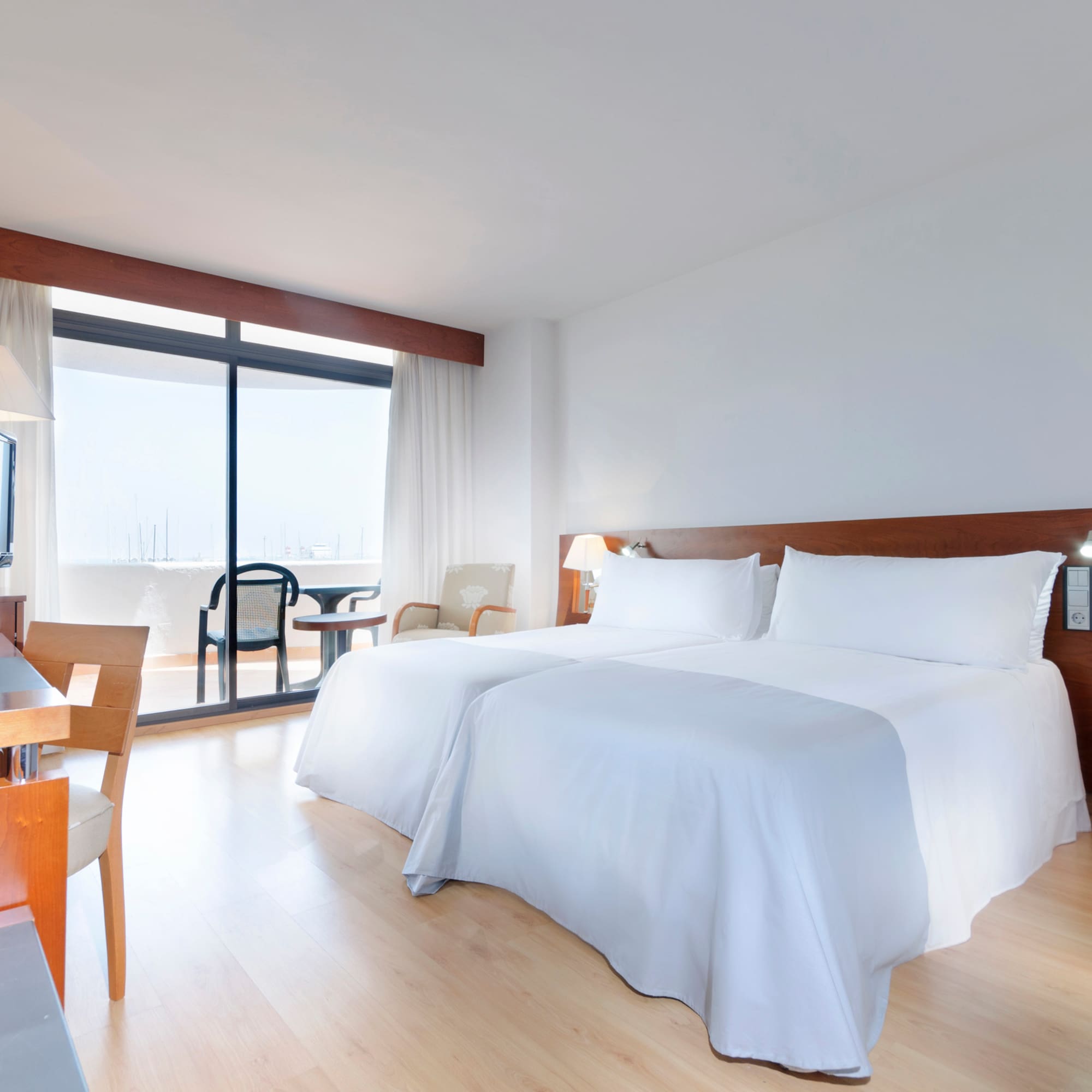 a room with two beds and a desk