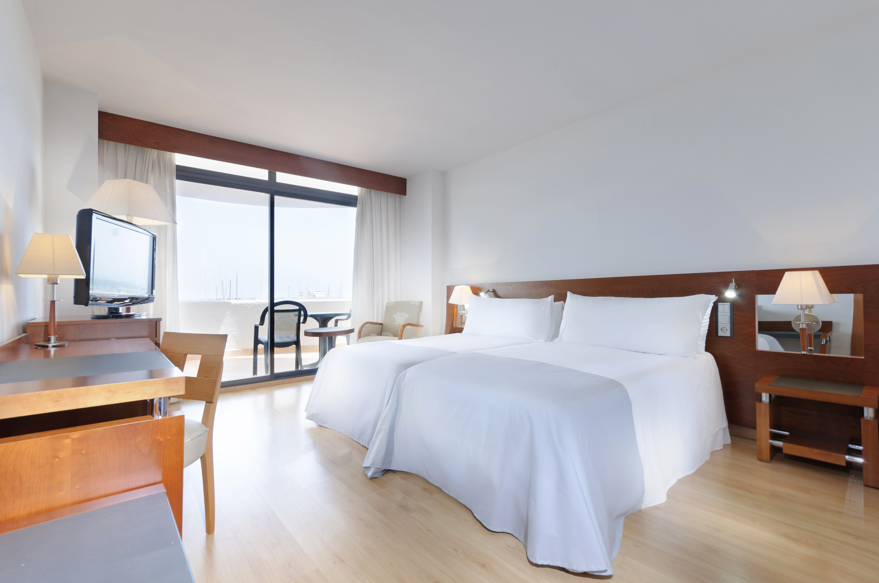 a room with two beds and a desk