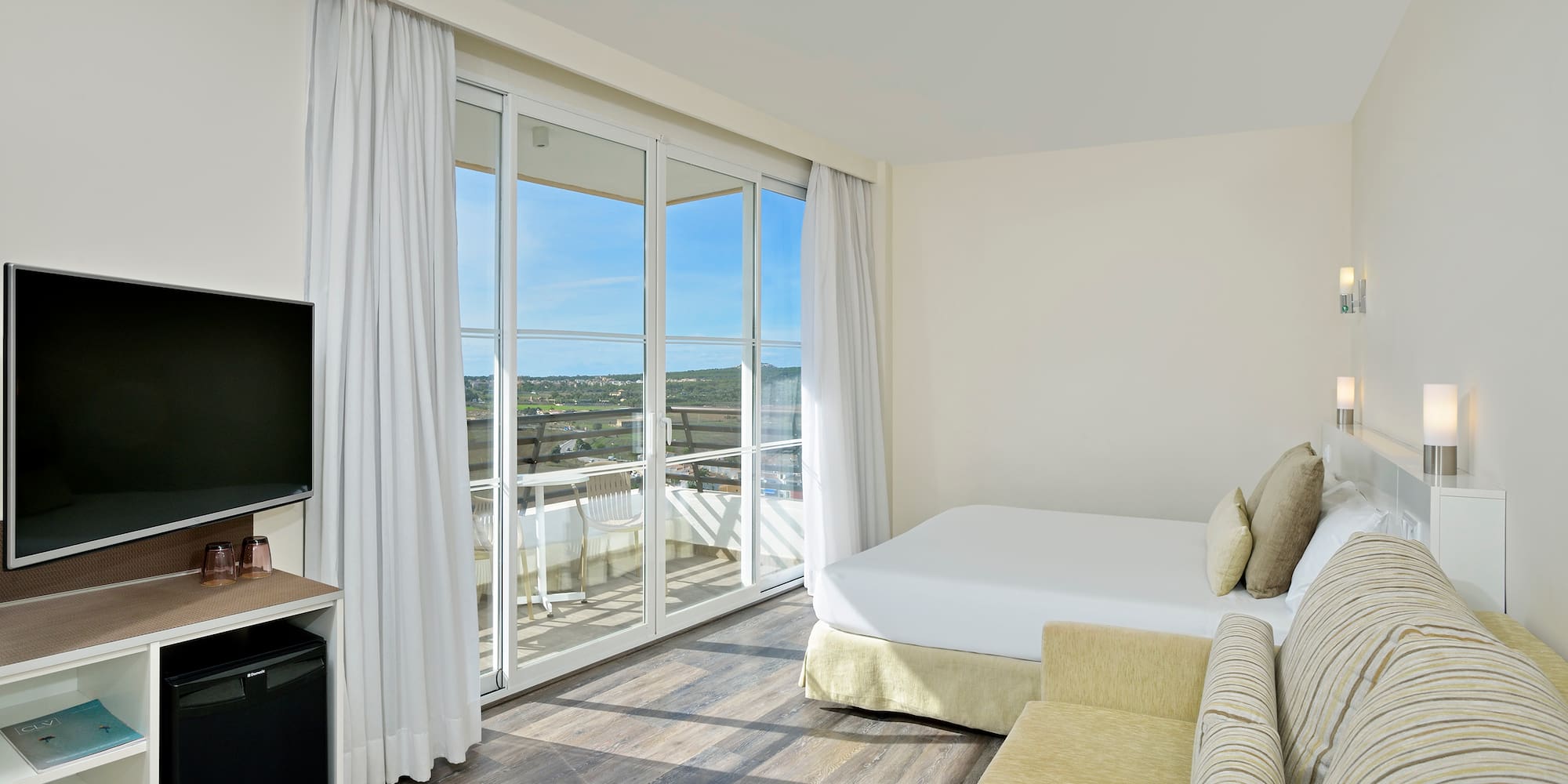 a room with a bed and a television