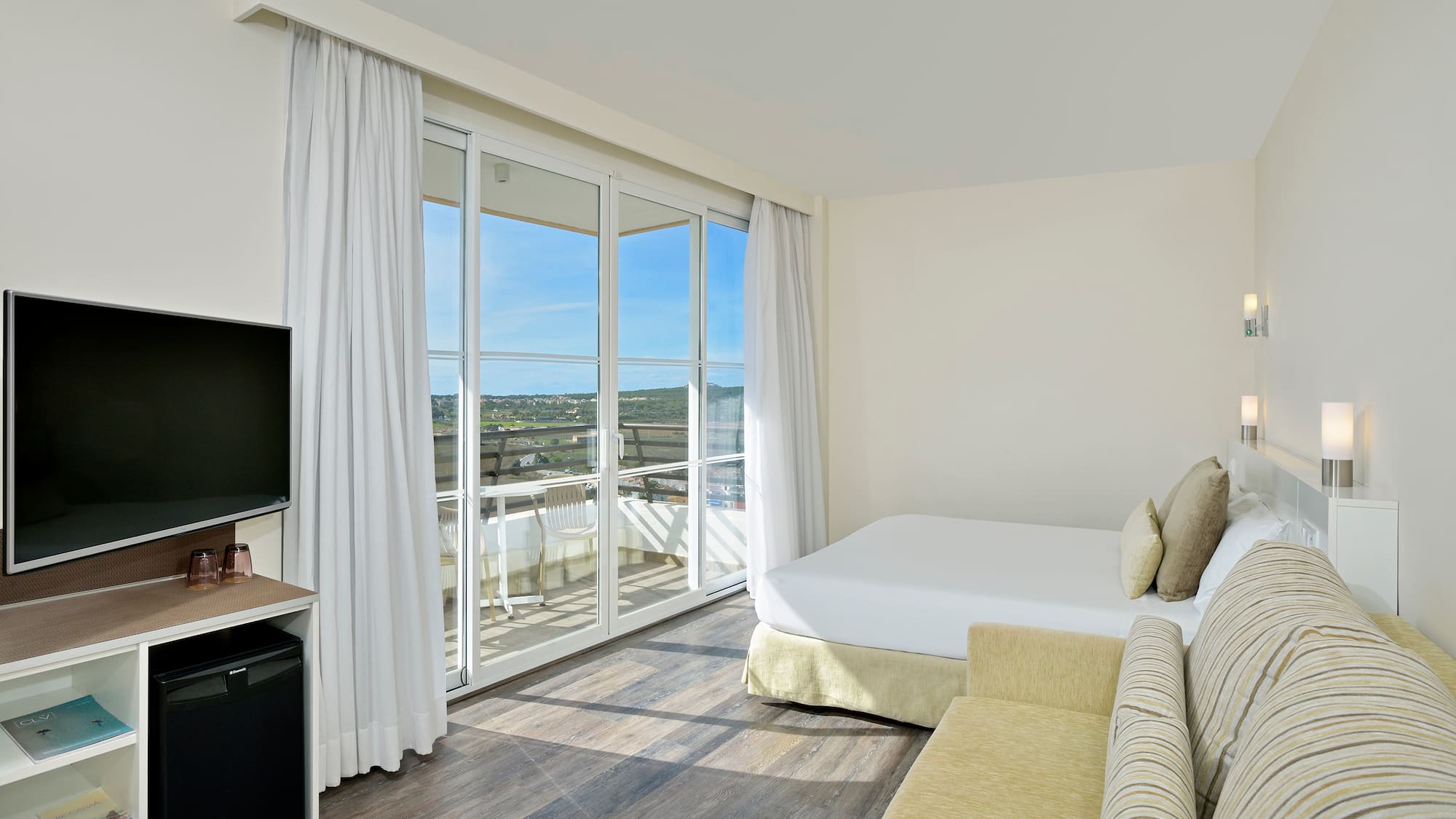 a room with a bed and a television