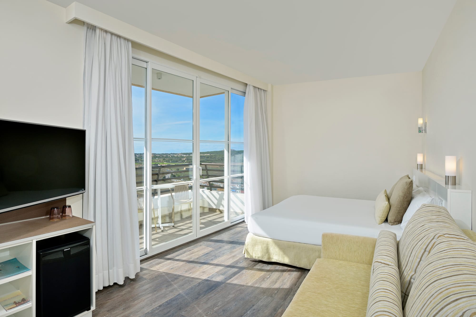 a room with a bed and a television