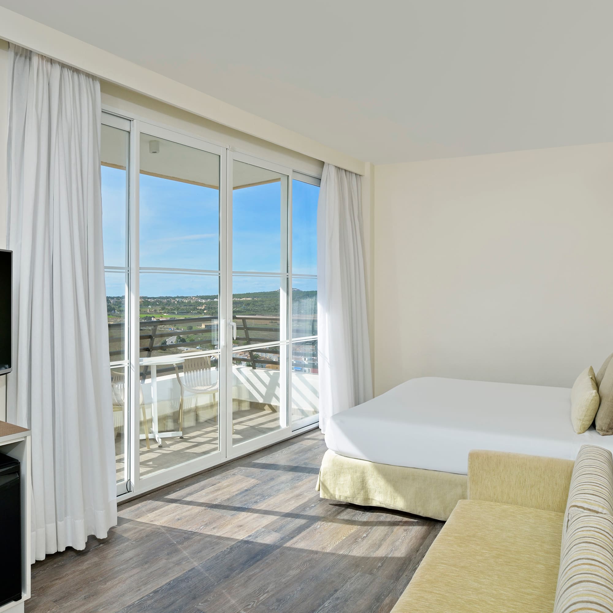 a room with a bed and a television