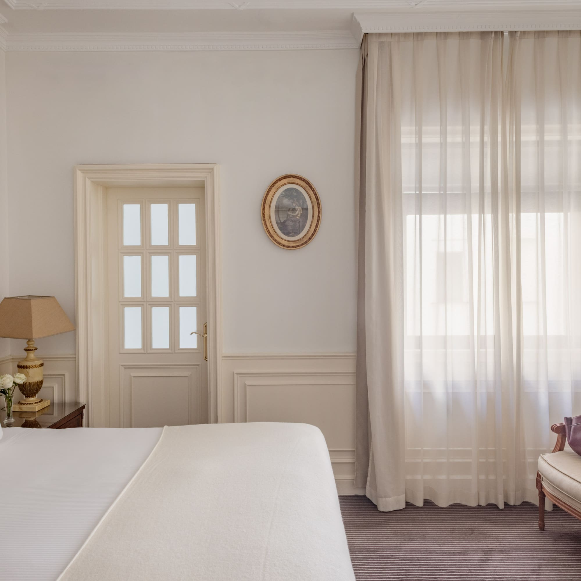 a bedroom with a bed and a chair