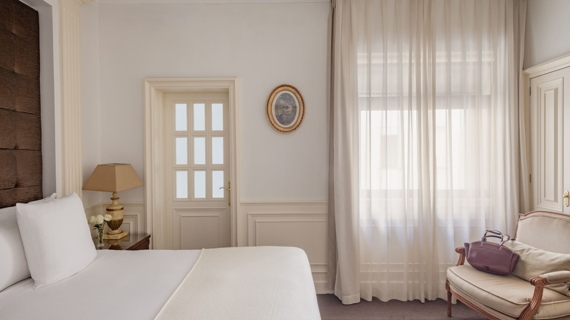 a bedroom with a bed and a chair